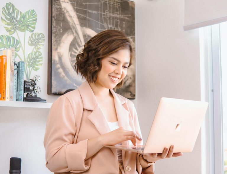 Woman in Coat with Laptop in Room