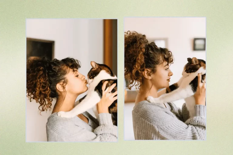 Woman holding a cat and kisses it